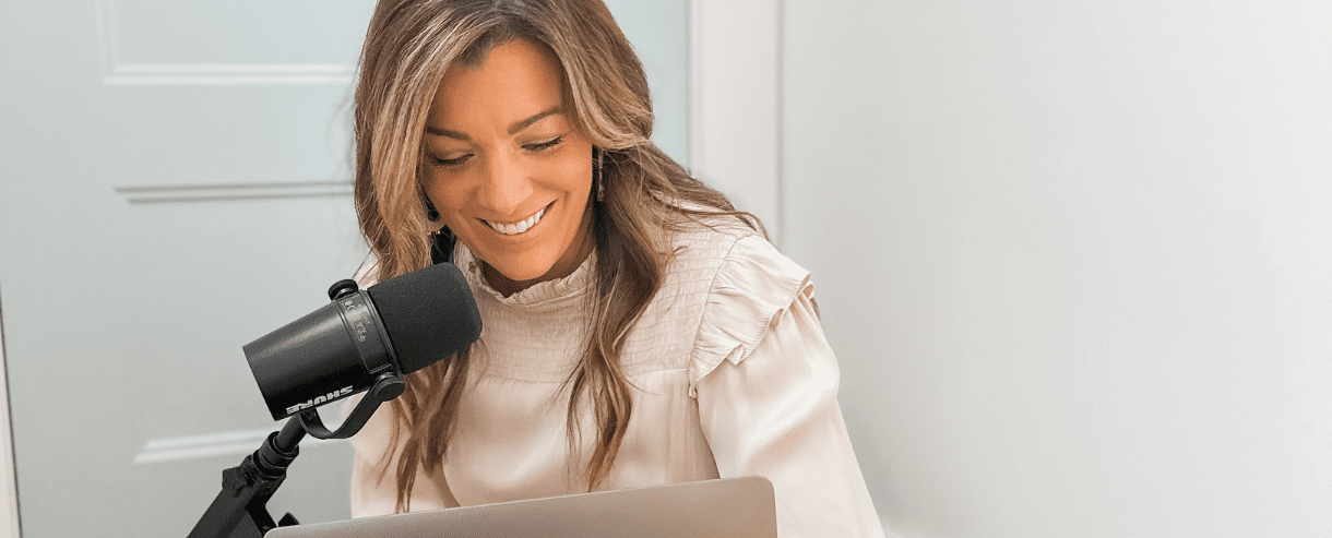 Woman talking in microphone and looking at computer